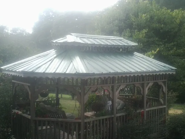 Two tier green metal roof on a garden gazebo in Taopi